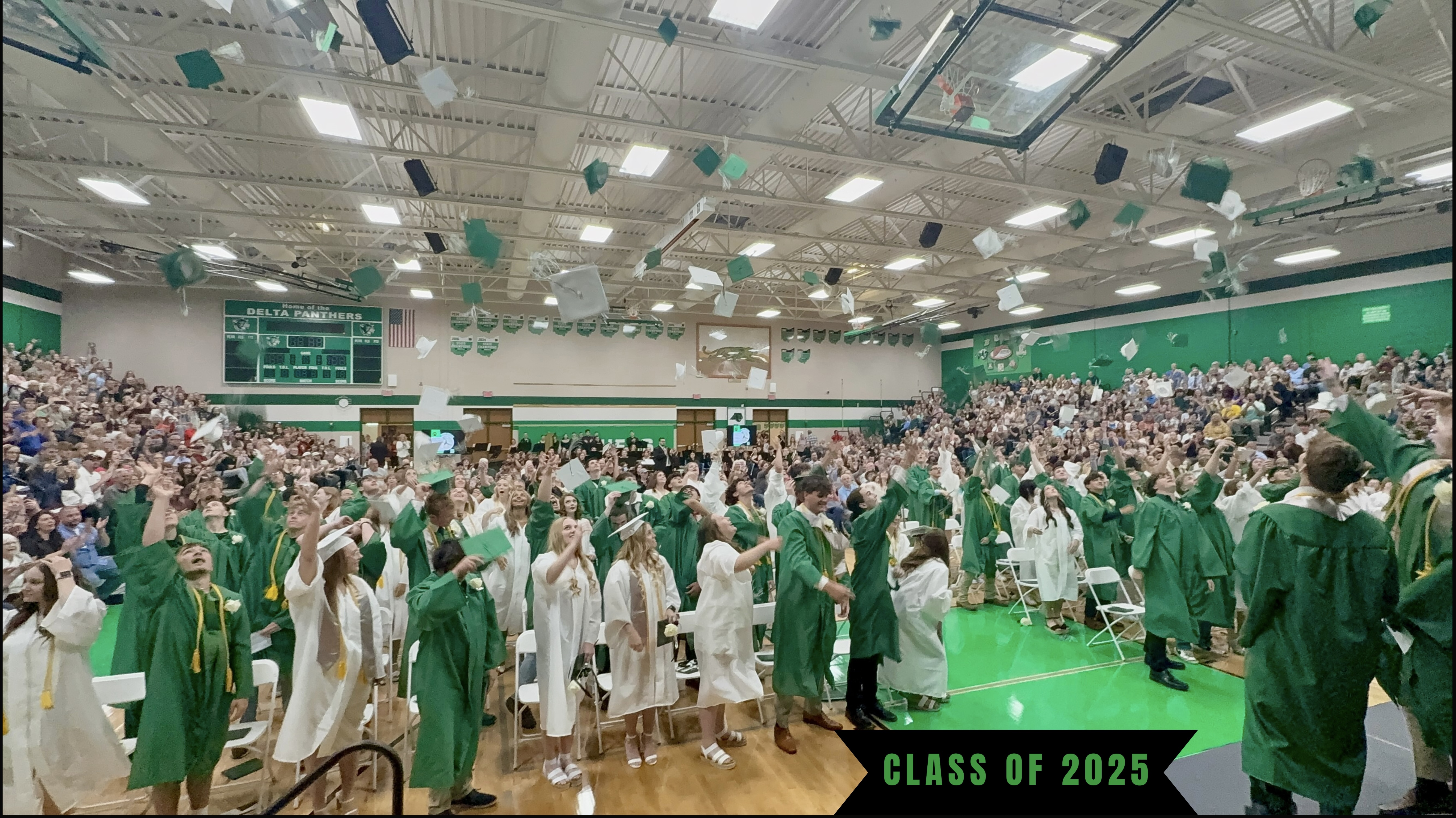 students tossing their caps in the air at graduation