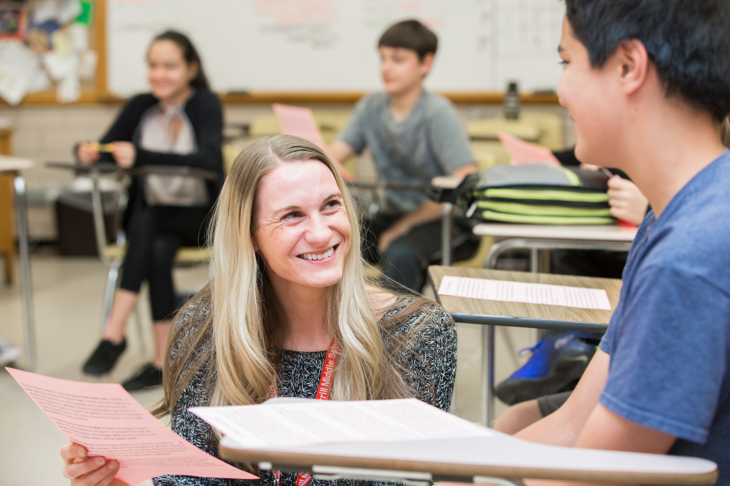 Middle School teacher smiling at student
