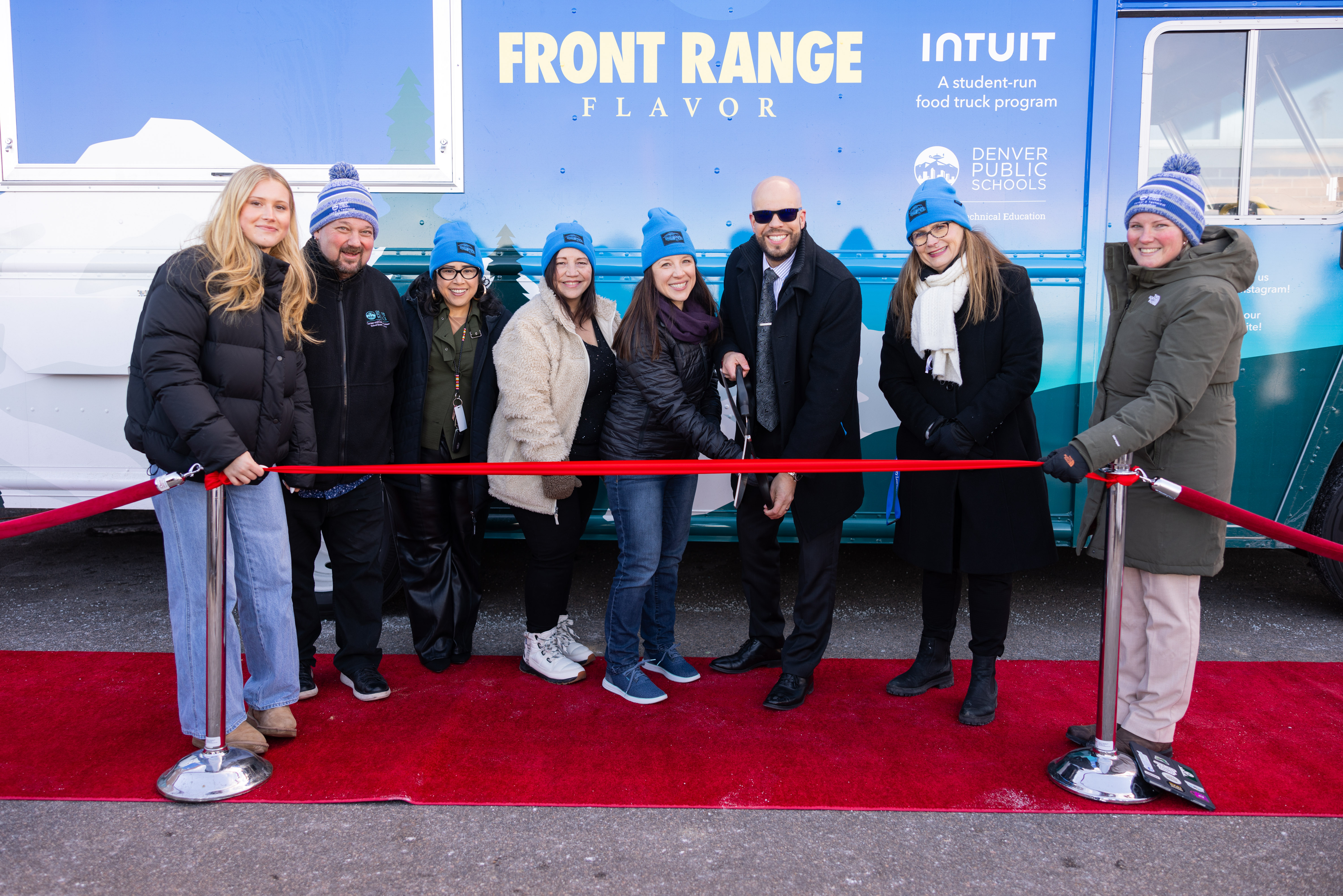 group photo of ribbon cutting ceremony in front of food truck