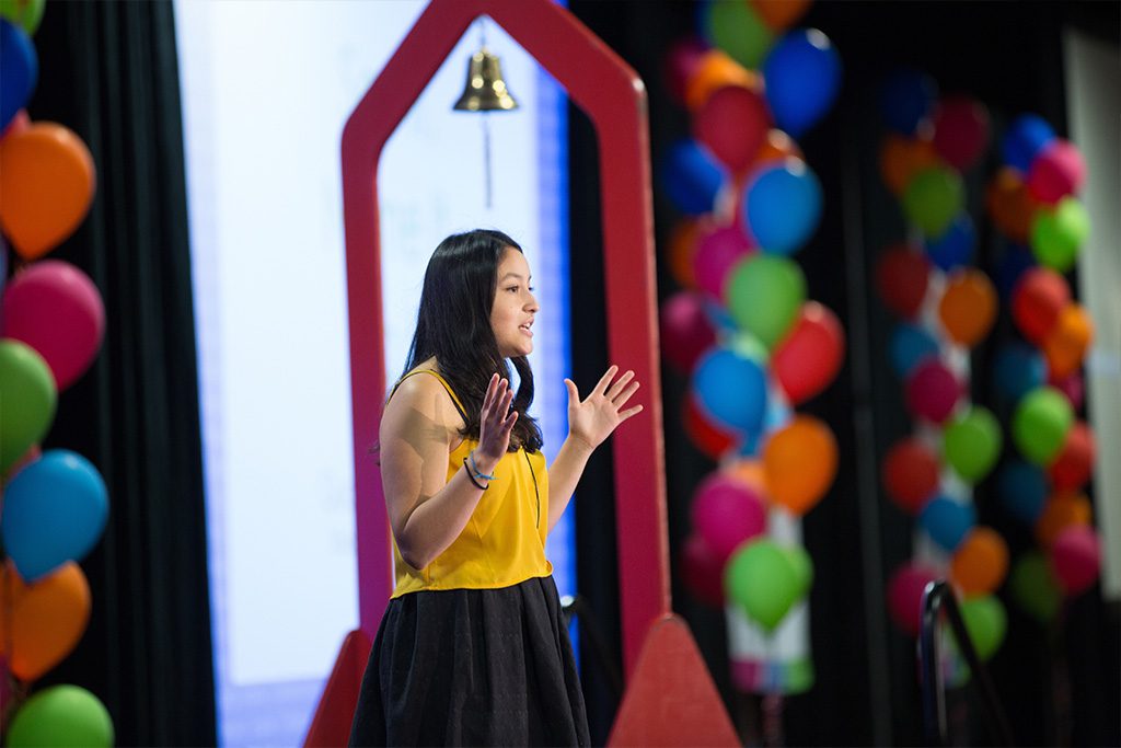 Teen girl giving a speech at school