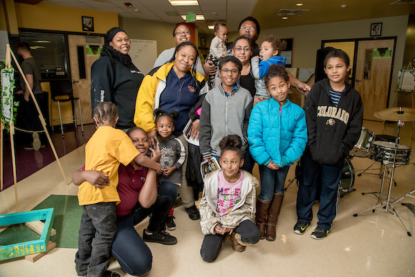 Group of students and teachers posing for photo at classroom