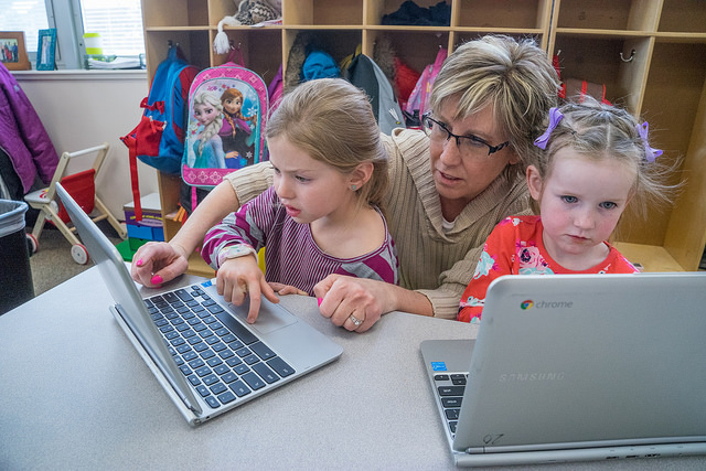 students and teacher using a chromebook