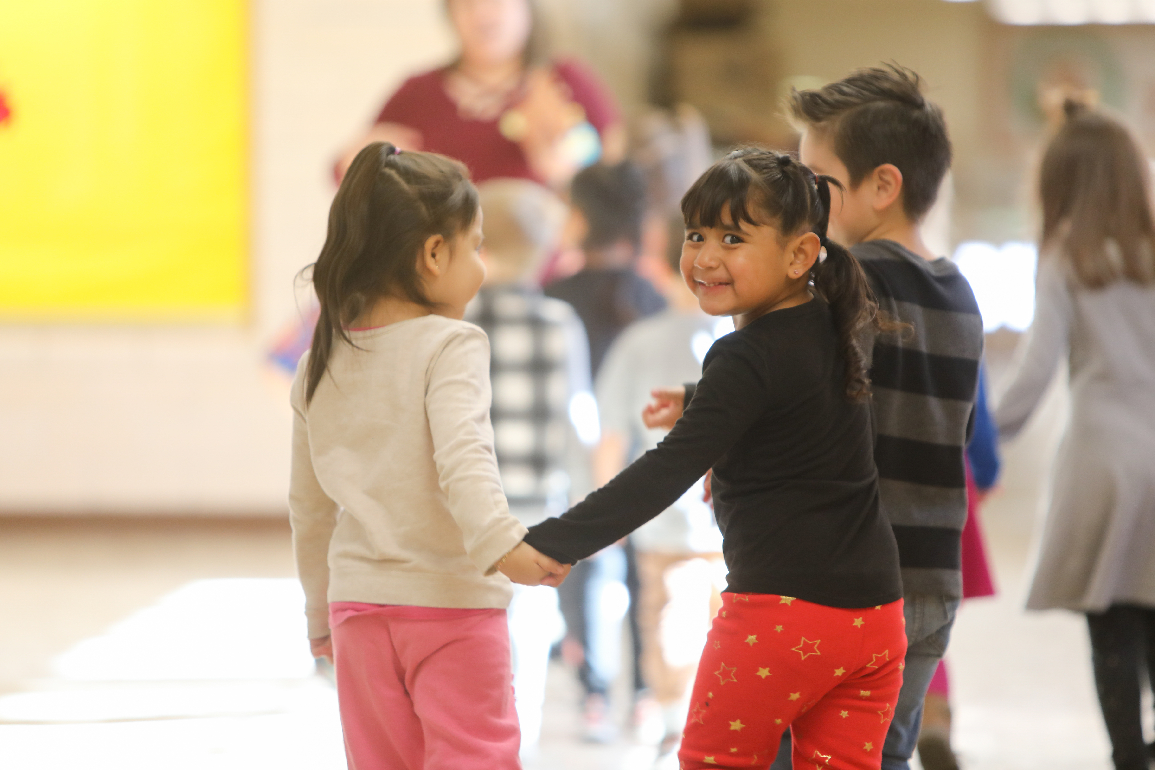 two students holding hands