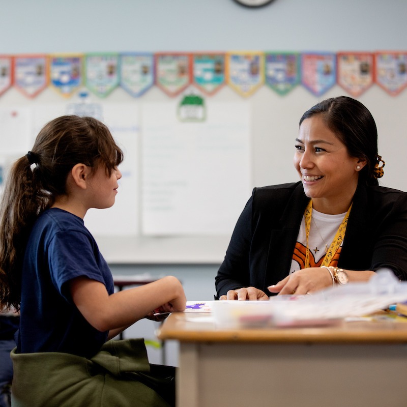 Student and teacher at desk