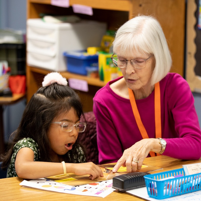 Student and teacher at desk