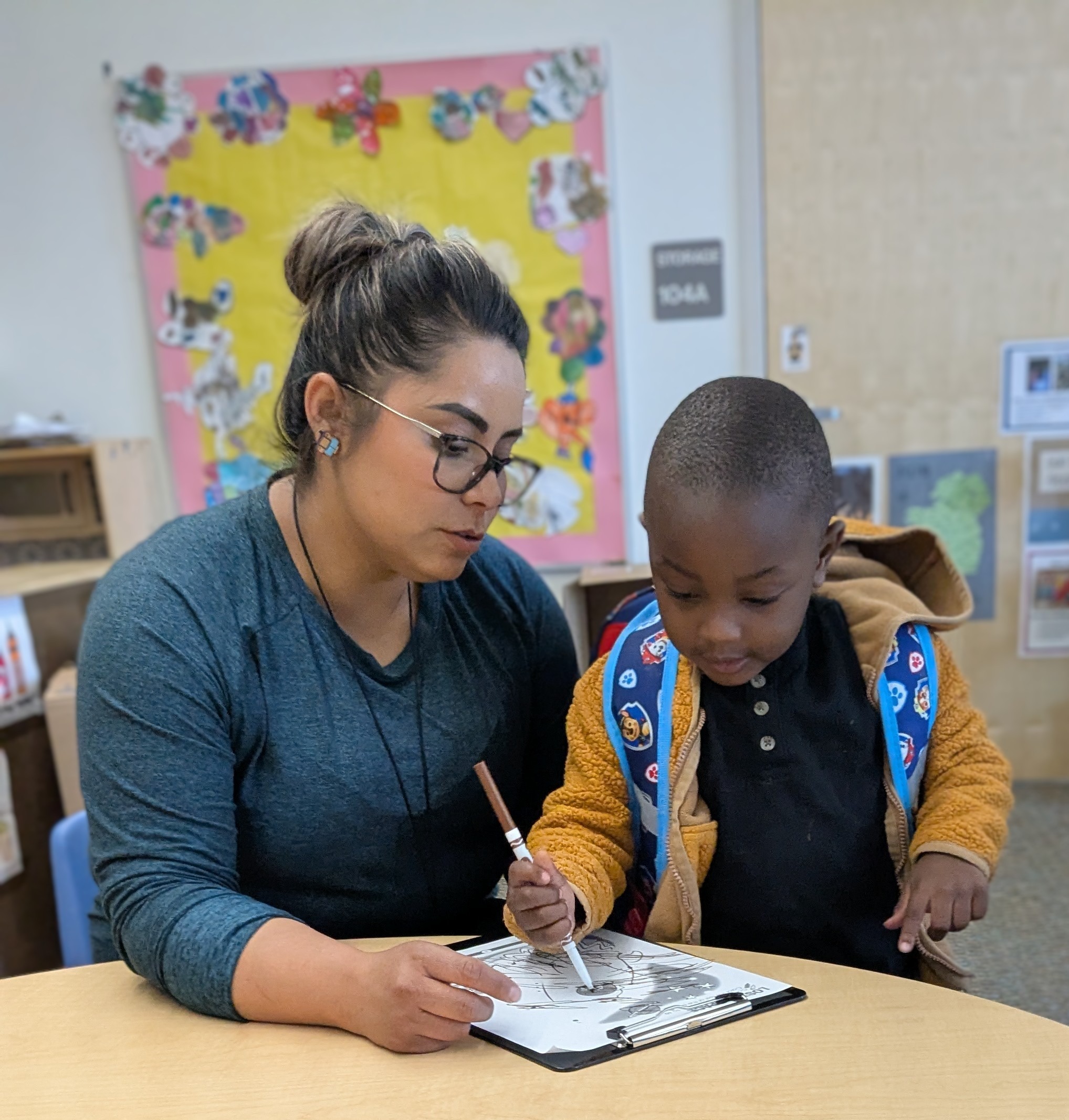 Teacher and student working at a table