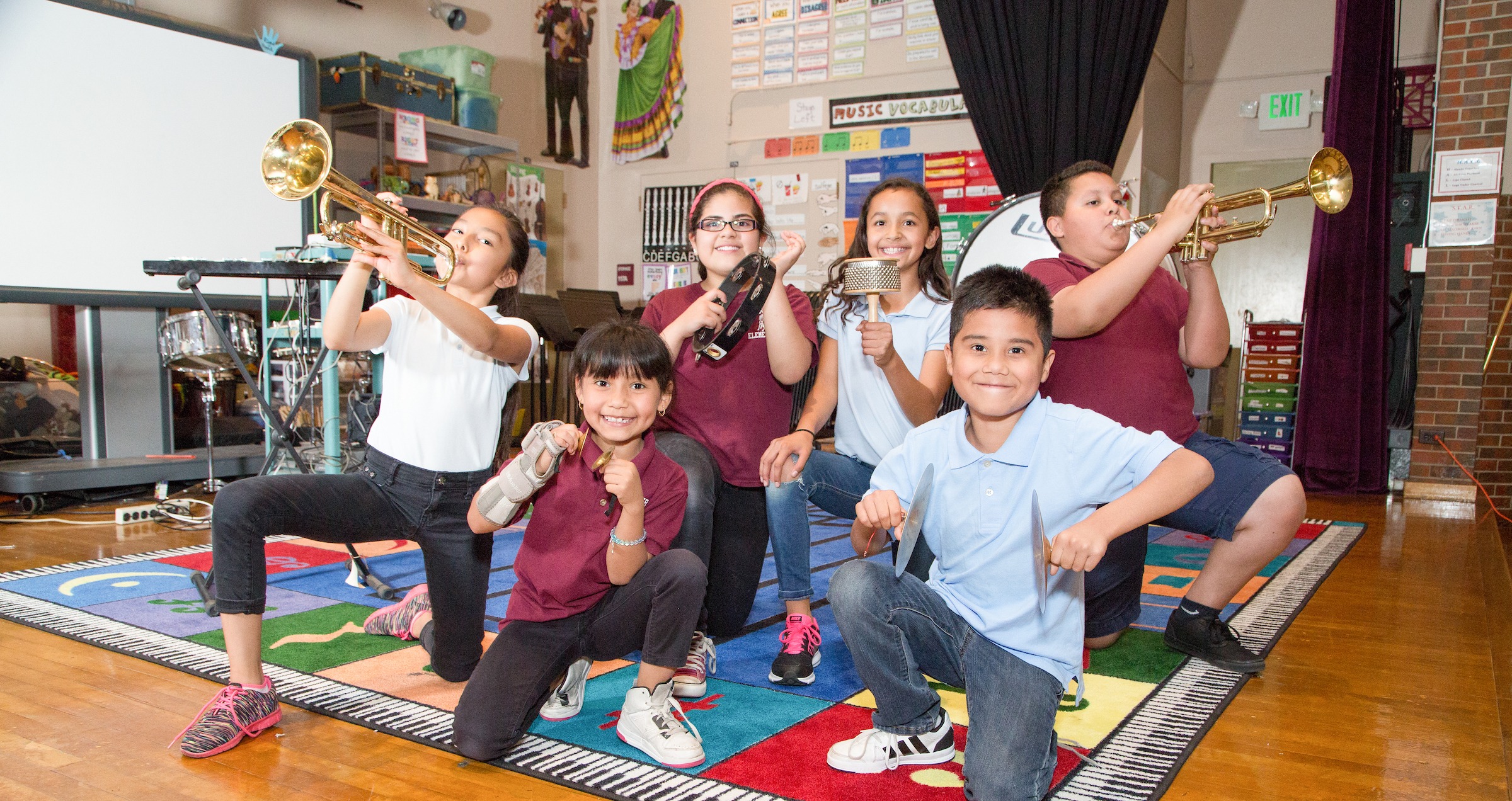 Group of students at music class holing their instruments