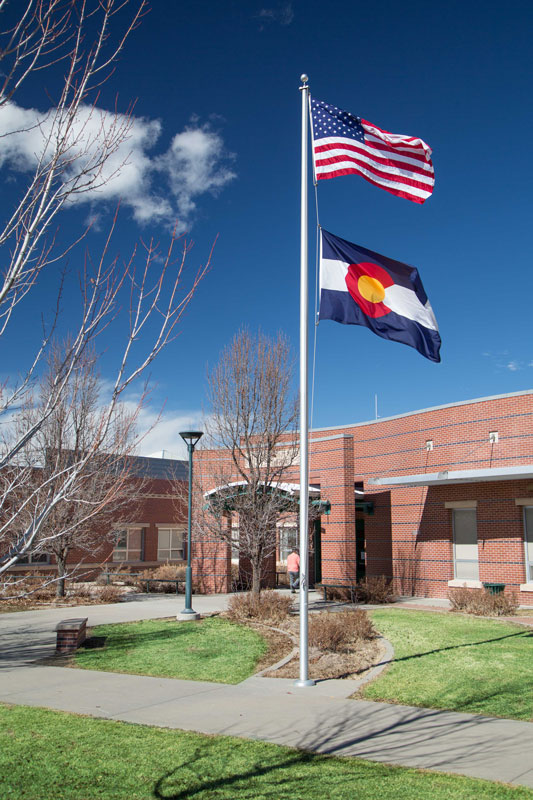 DPS building, flag of Colorado and USA waving on the yard.
