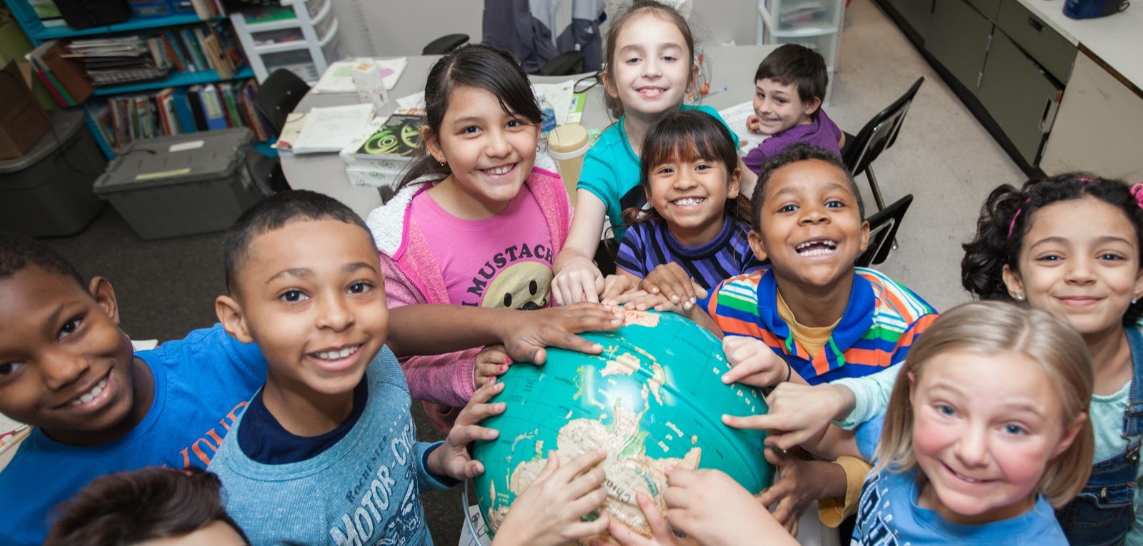 Group of kids holding a globe