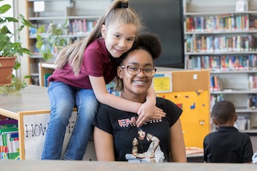 Two children in library.