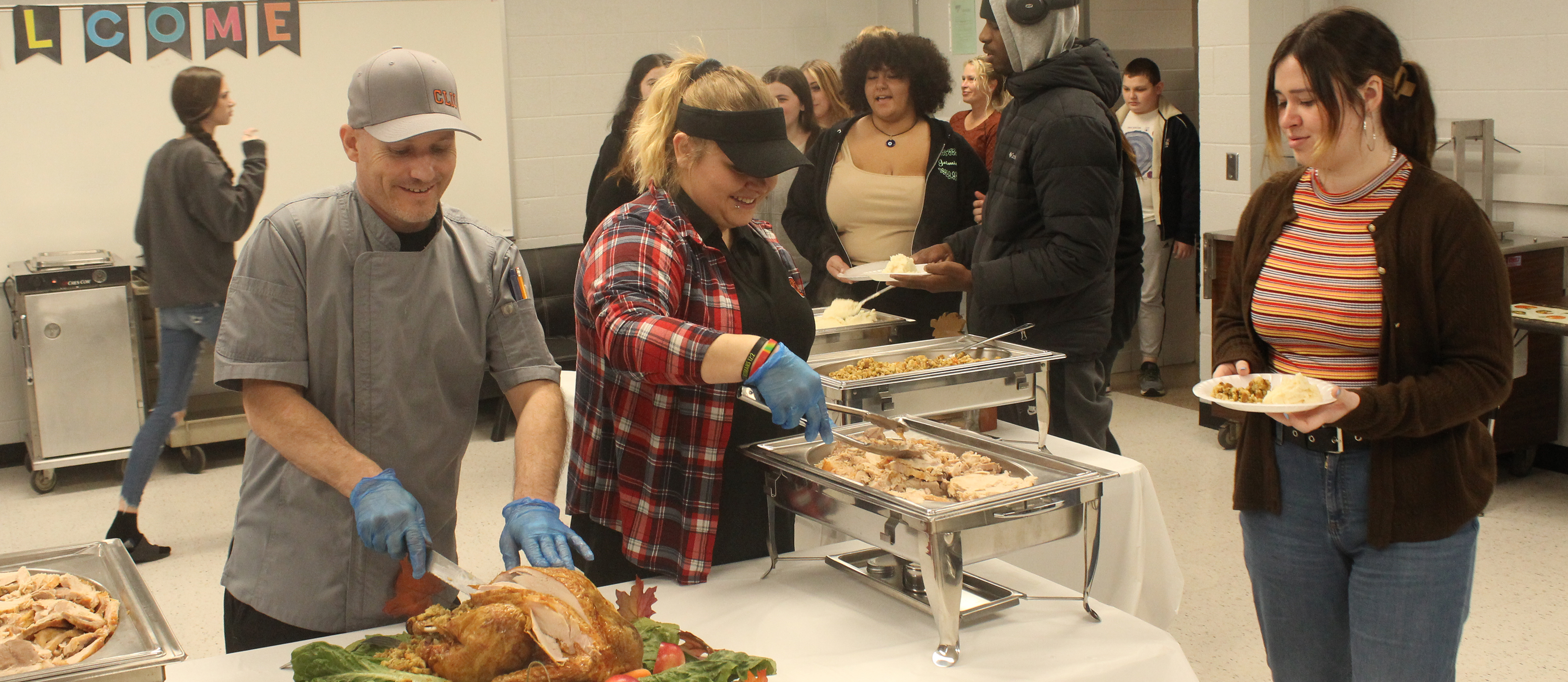 Photo of Thanksgiving dinner being served to students and their families as well as staff