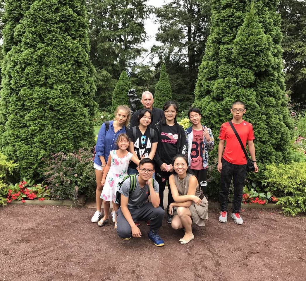 Students posing for the picture by the trees