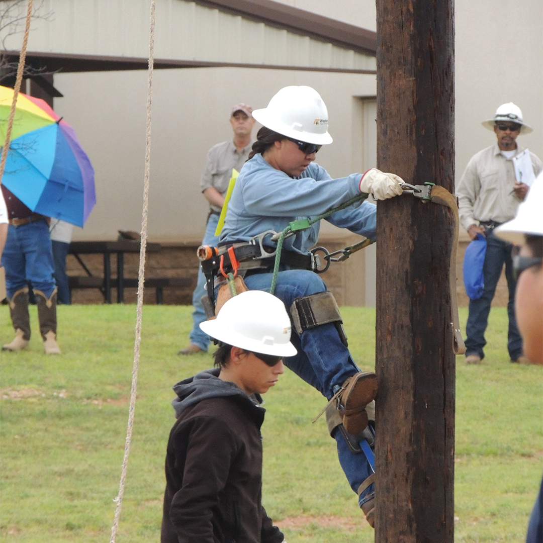 Lineworker climbing pole