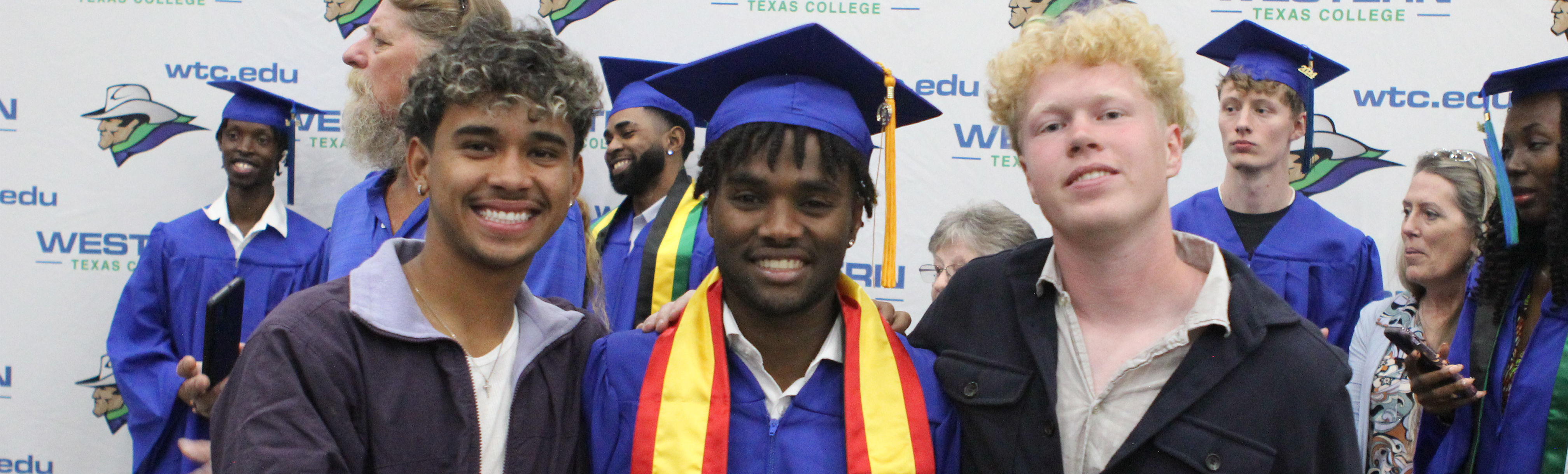 3 students at graduation