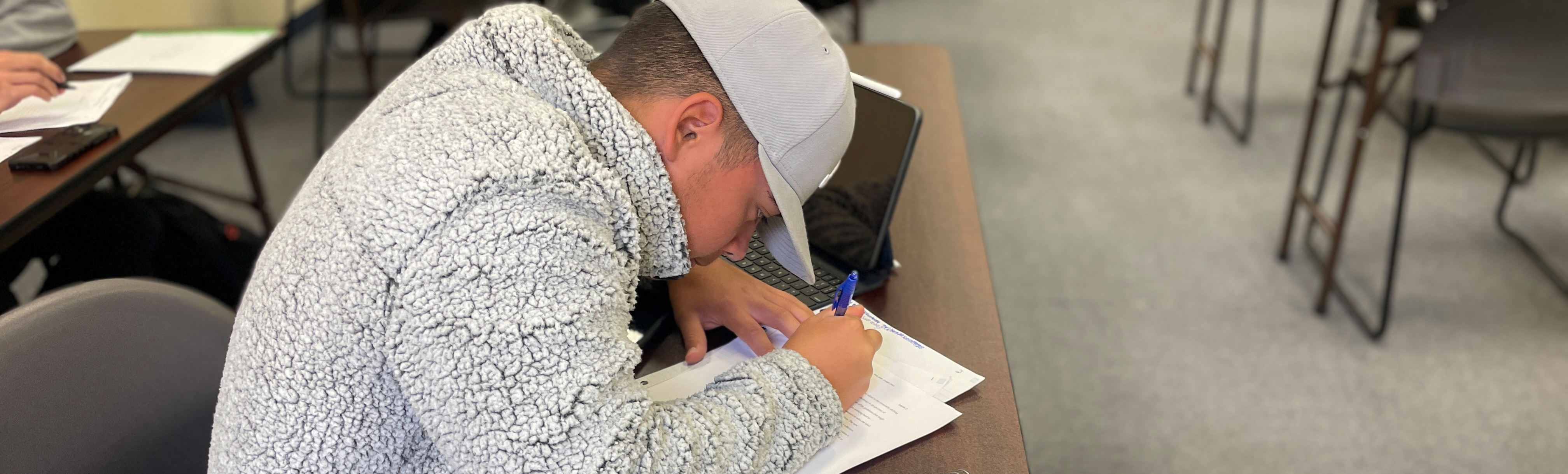 Student writing in English class