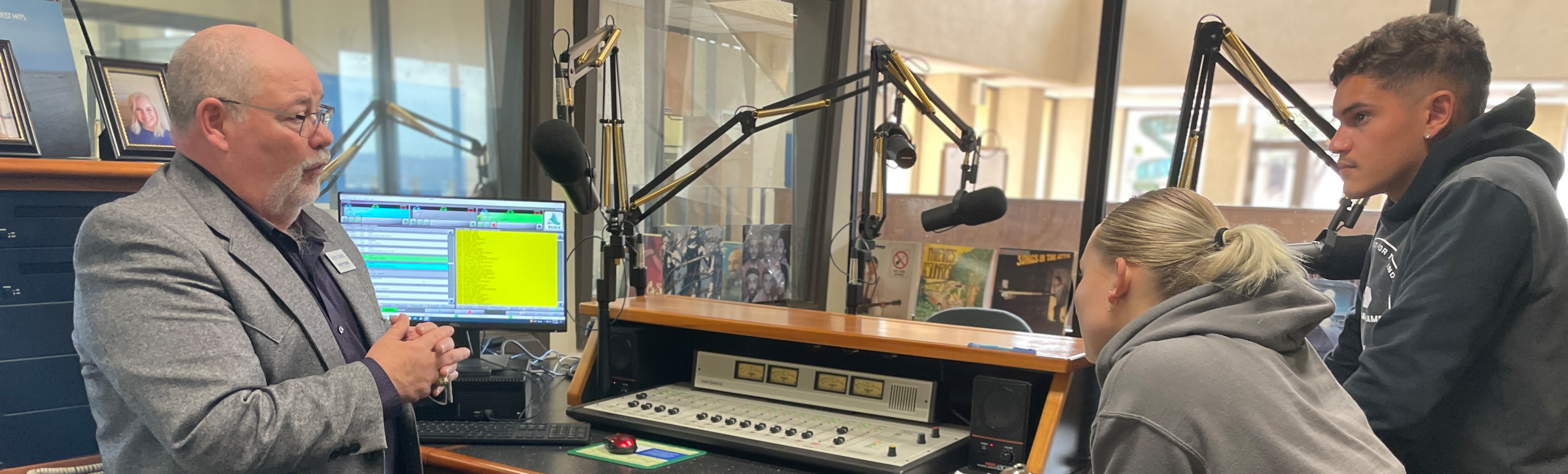 Professor teaching students in radio room