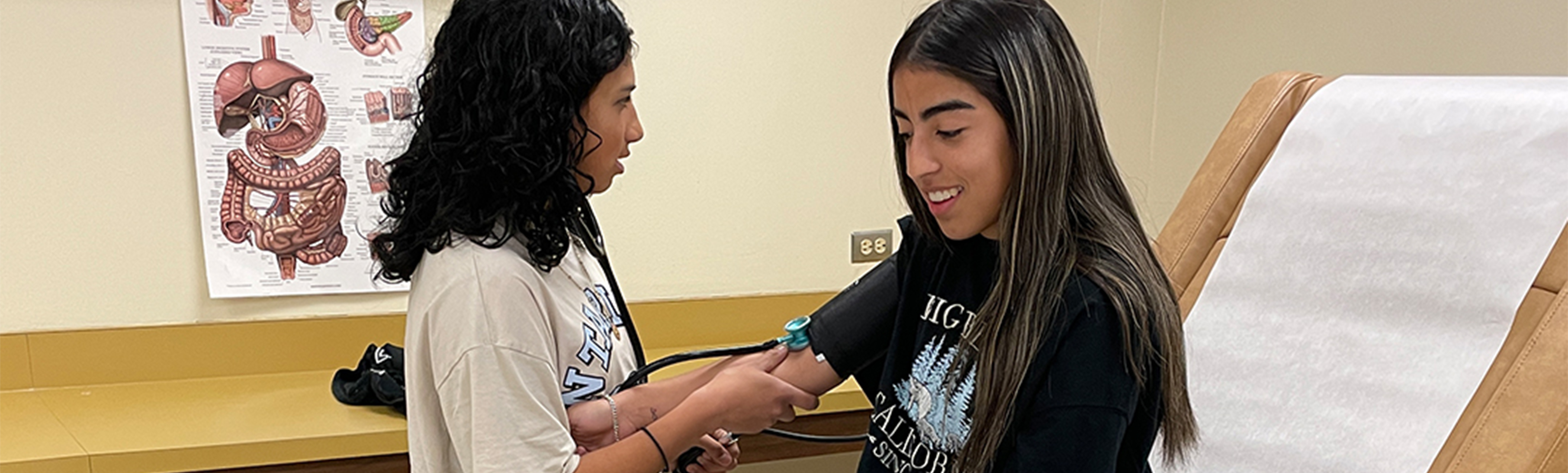 Student checking pulse of another student