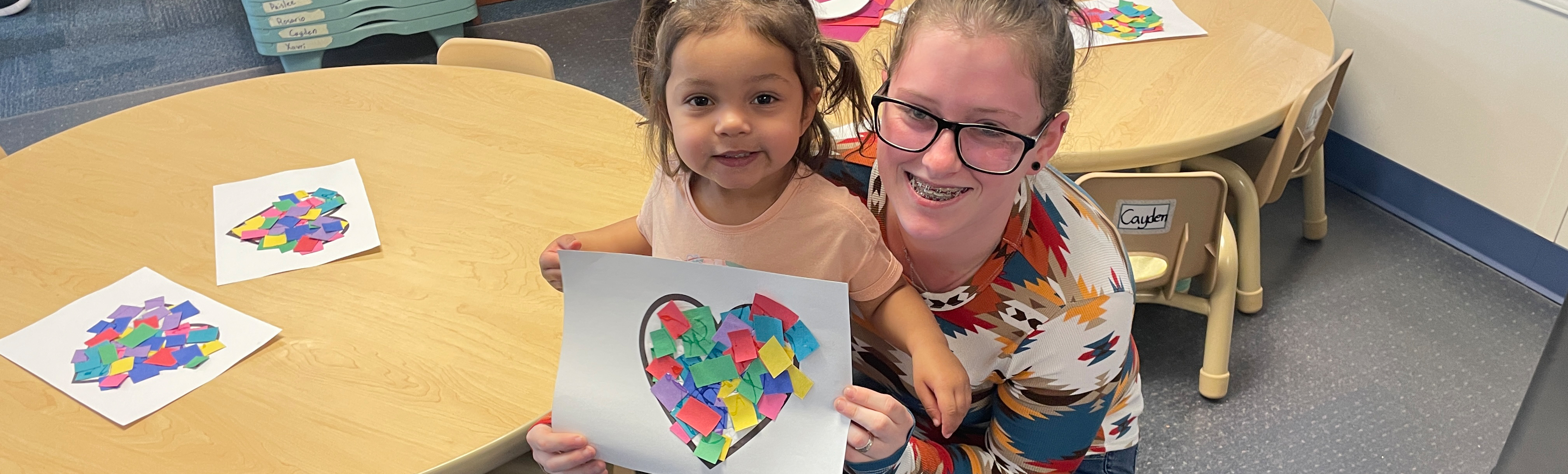 Teacher with toddler and craft