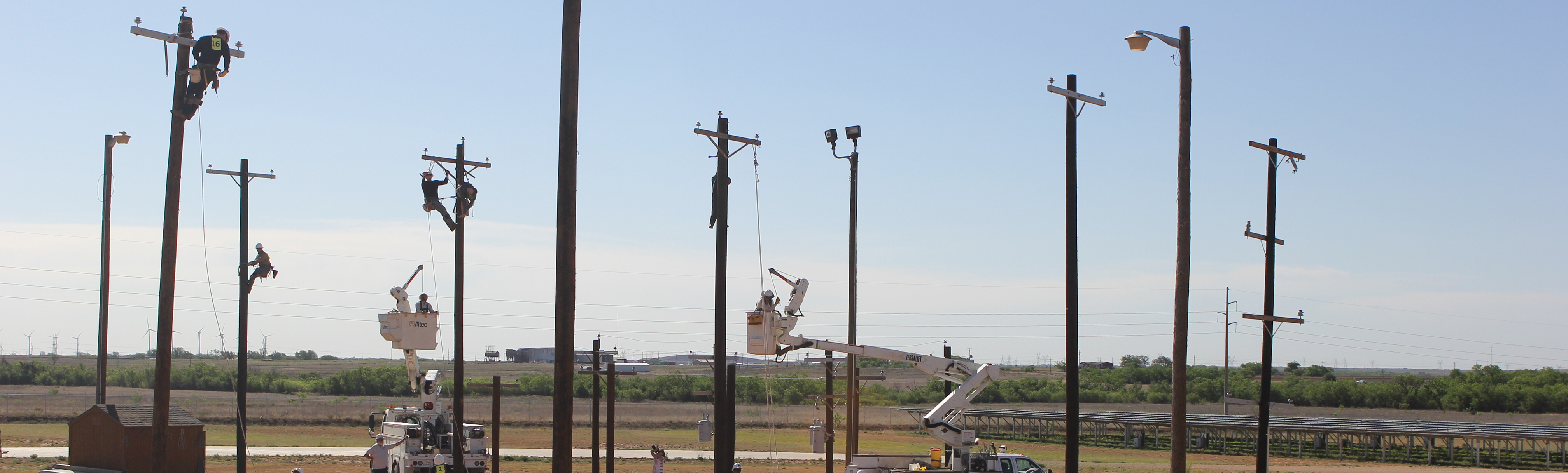 Lineworker Rodeo: Students climbing electric poles