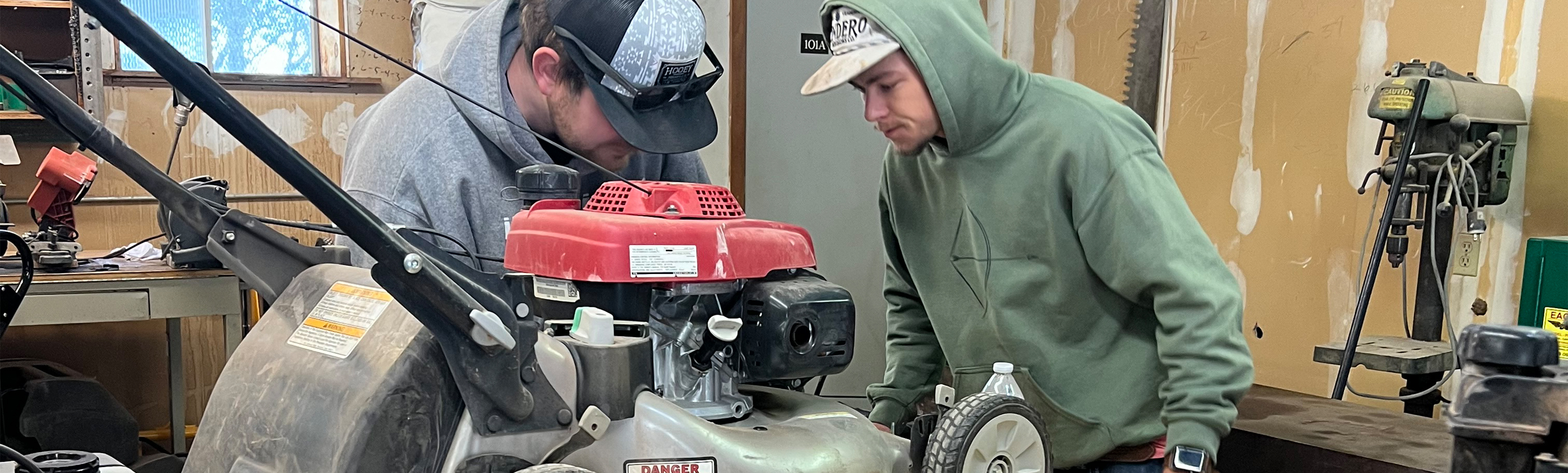 Students repairing lawnmower