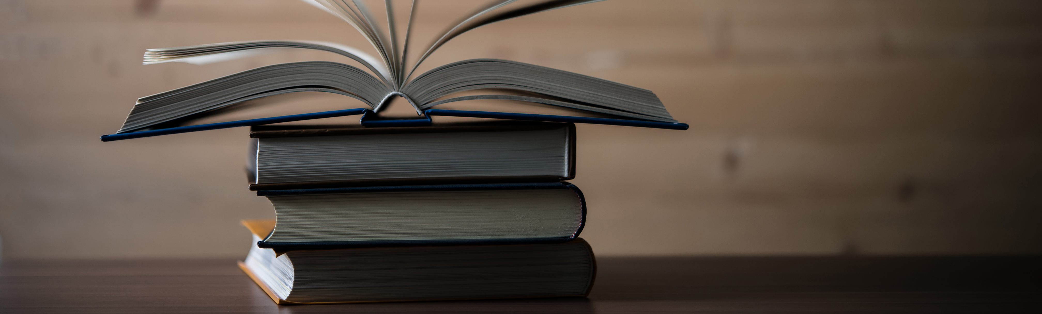 Stack of books with open one on top