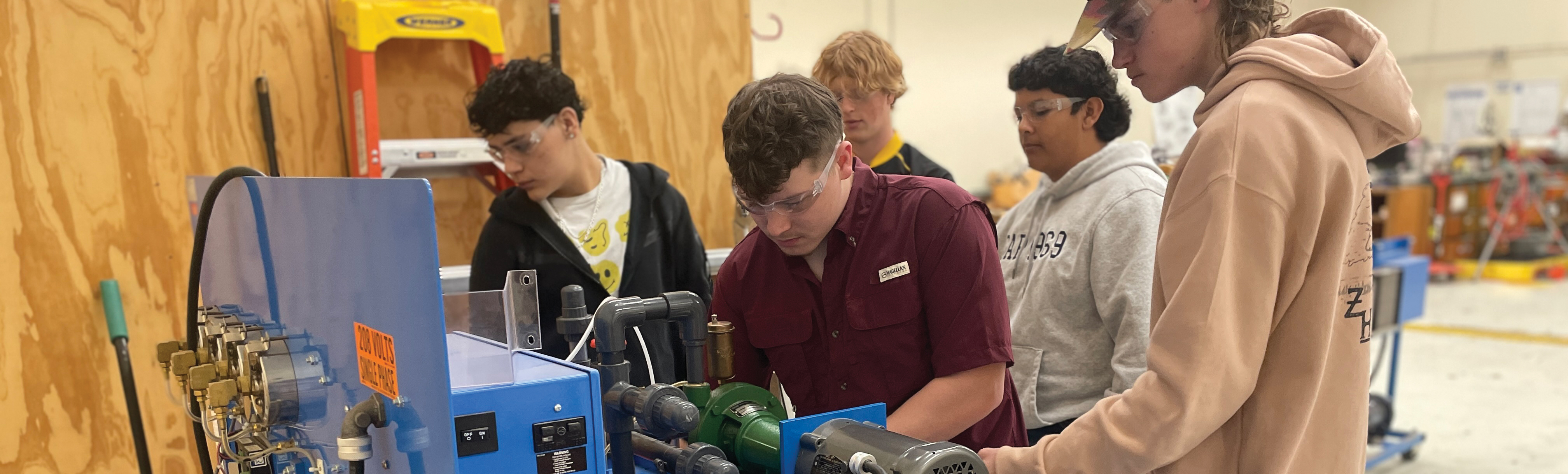Students working on petroleum machine