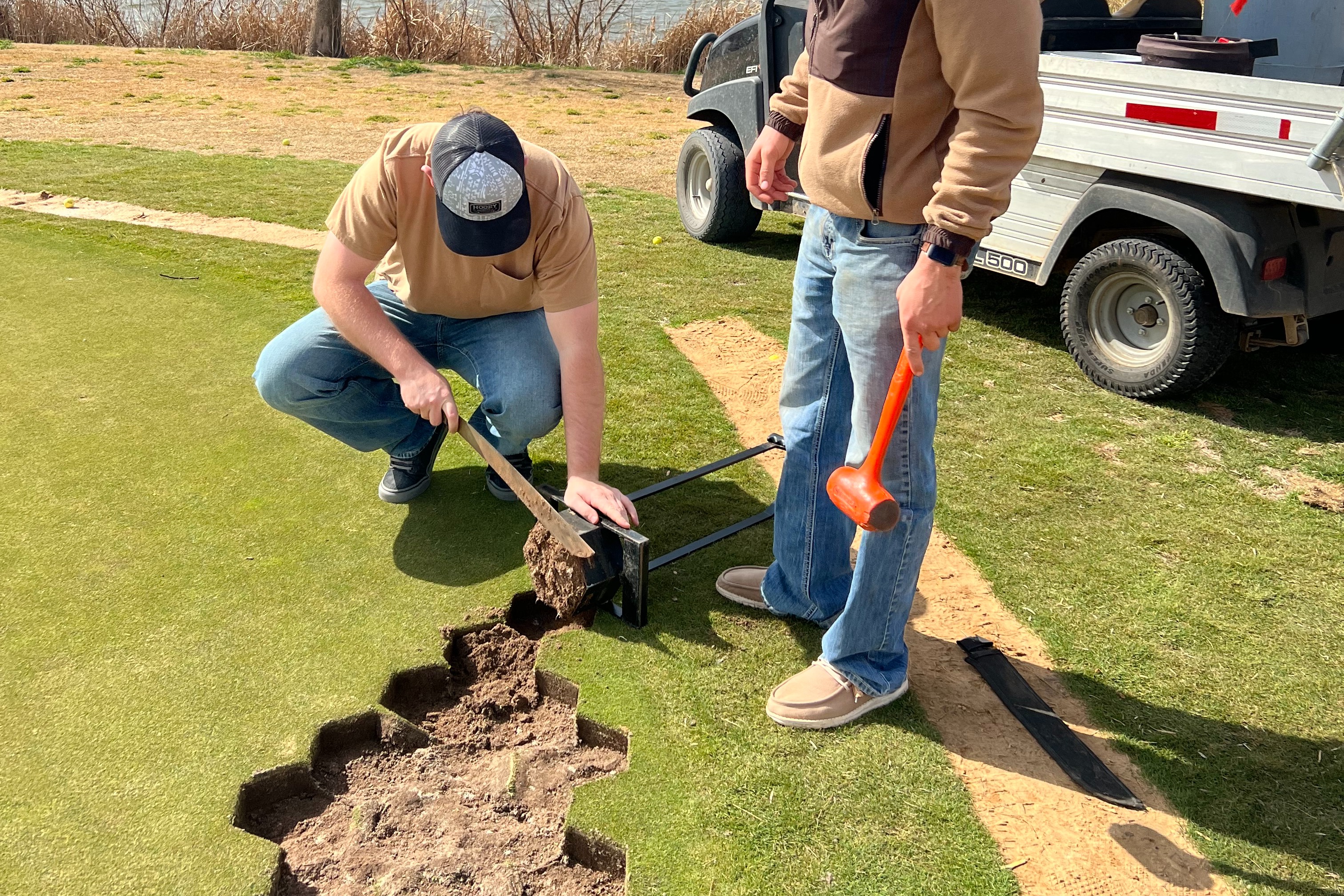 Students cutting golf course grass