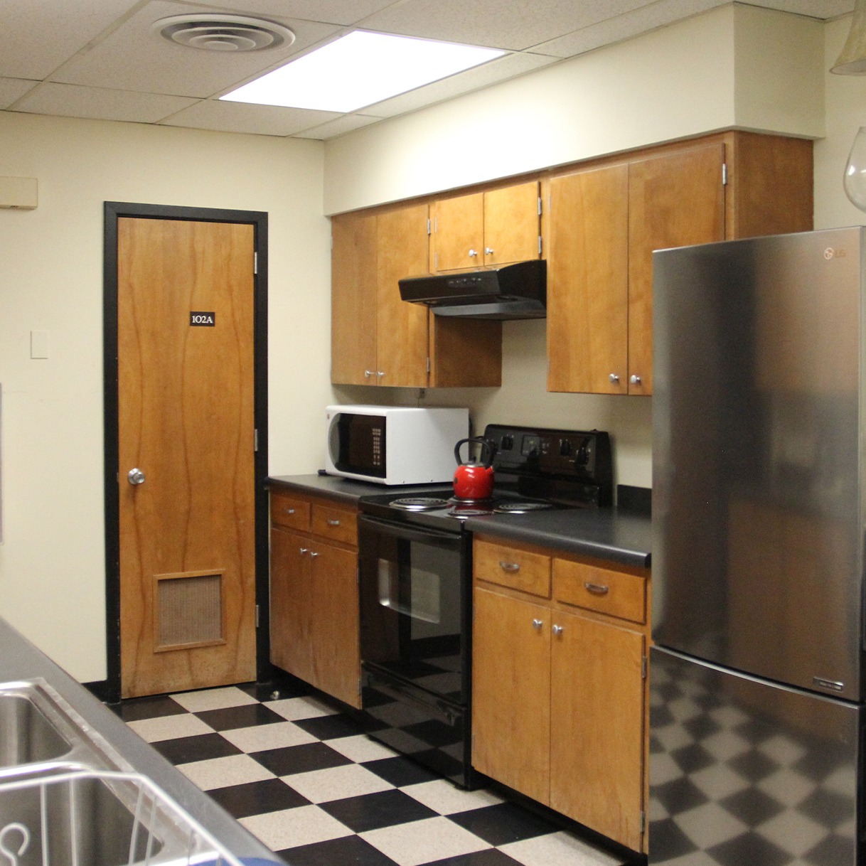 Kitchen area of the Visitor Center showing cabinets, stove , and refrigerator.
