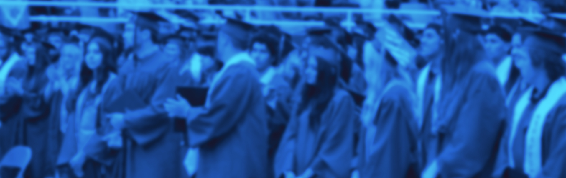Blurred image of students at graduations with blue overlay