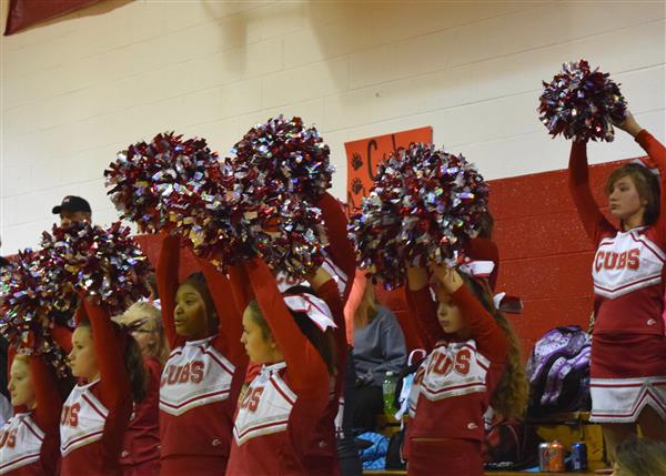 cheerleaders dancing during a game with their uniforms