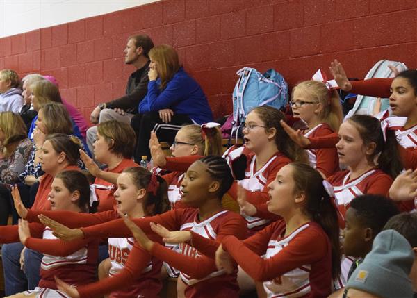 cheerleaders seated during a game watching excited