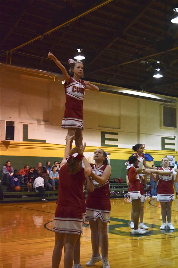 cheerleaders doing acrobatic choreography 