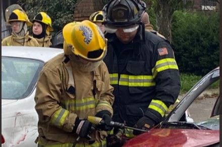 Fire science high school student praticing cutting open a car door