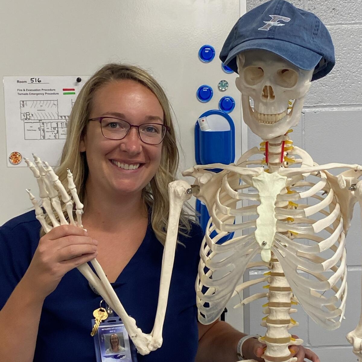 Teacher Hannah Doughty photo posing with a teaching skeleton