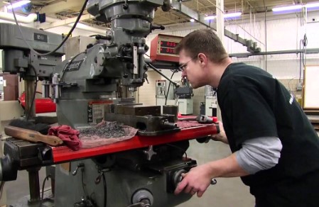 machinist oeprating a piece pf machinery