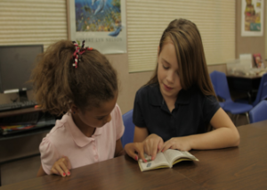 teacher reading with a student