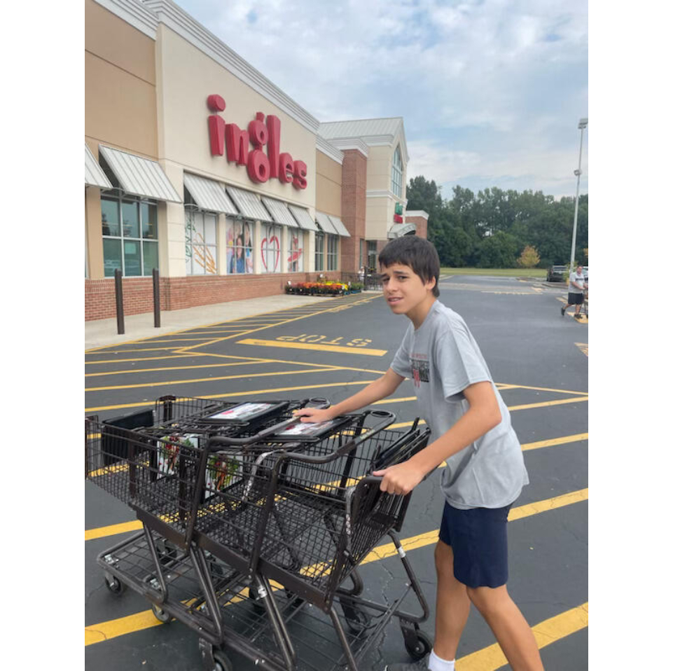 A student moving a shopping cart train