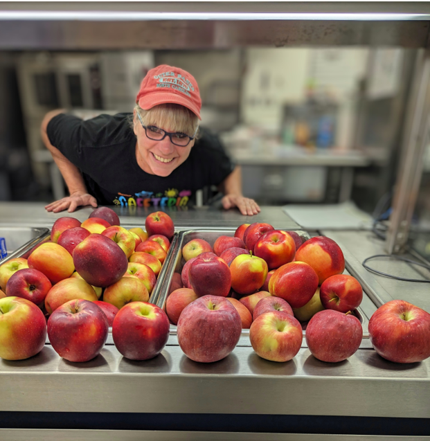 cafeteria worker with apples