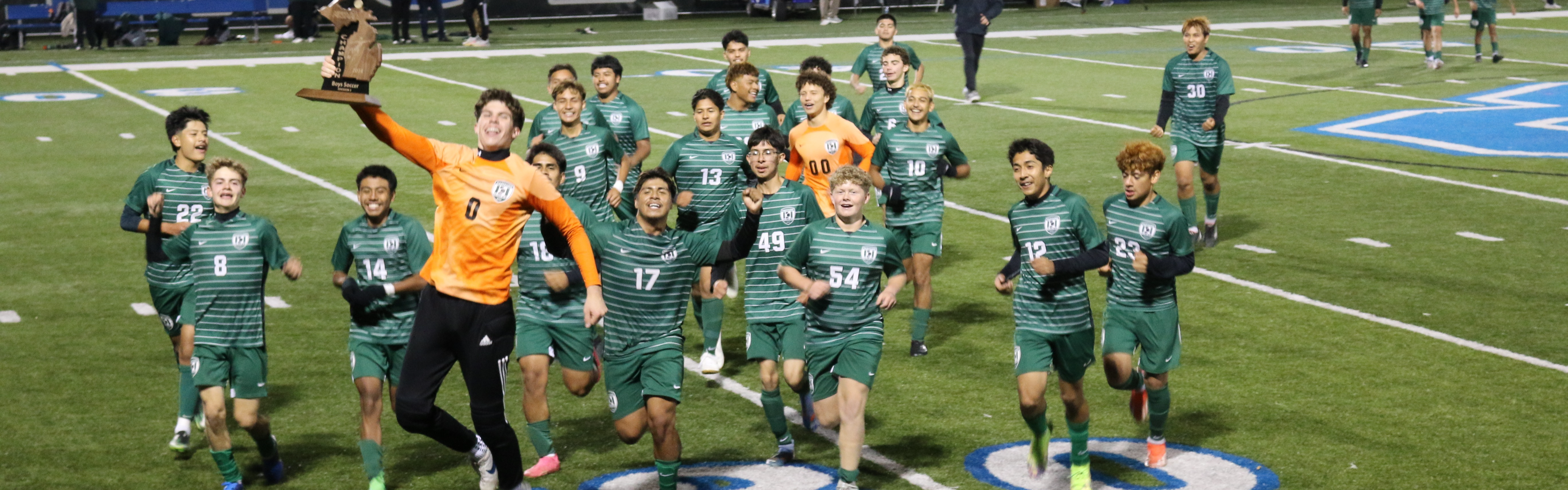 varsity boys soccer celebrates after winning the regional championship