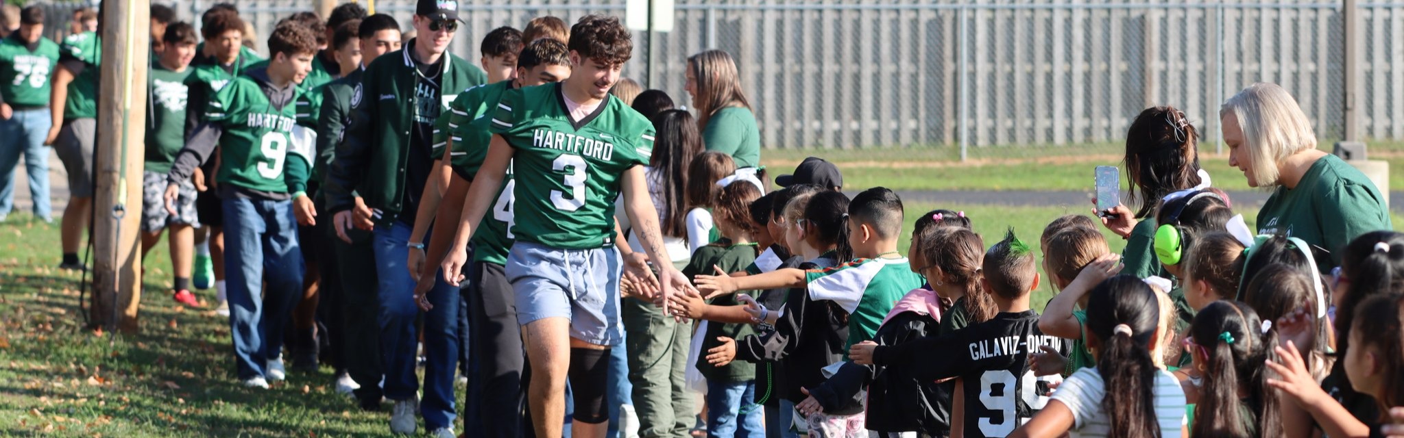 hartford football players greet the elementary students