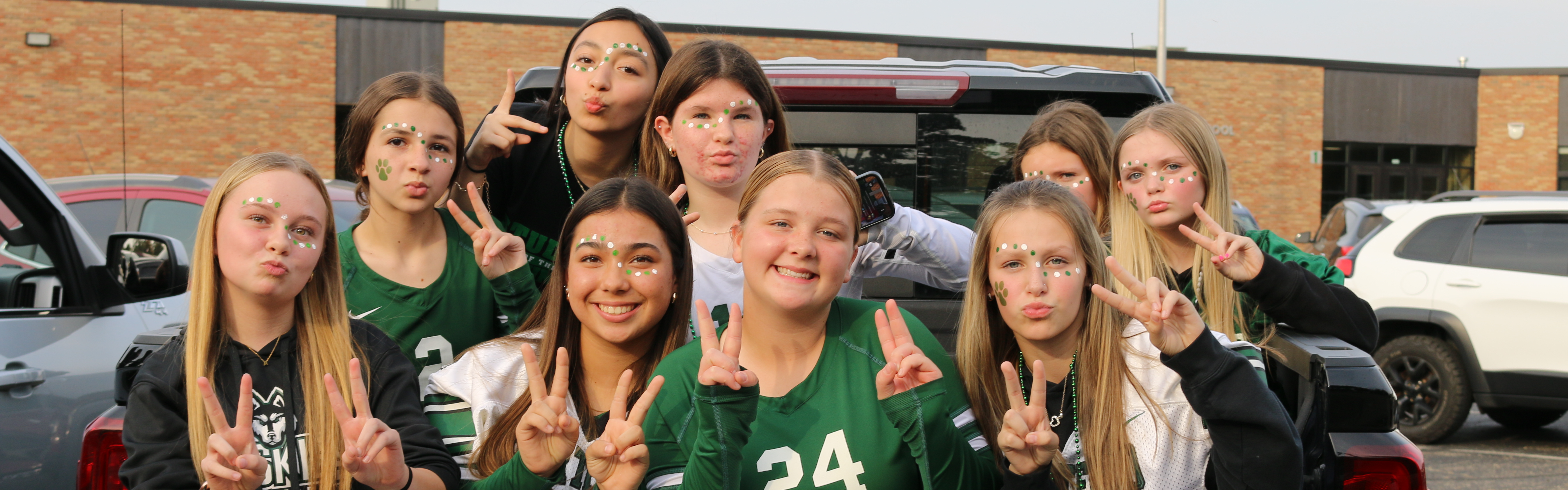 middle school volleyball team poses for a picture during the homecoming parade