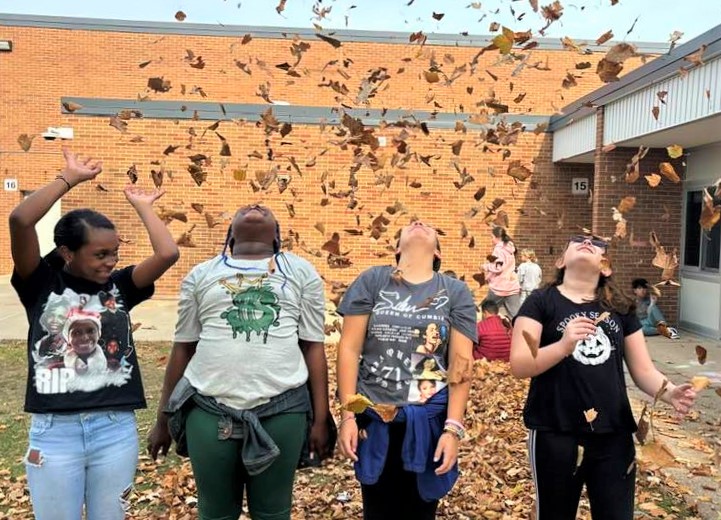 kids playing with leaves