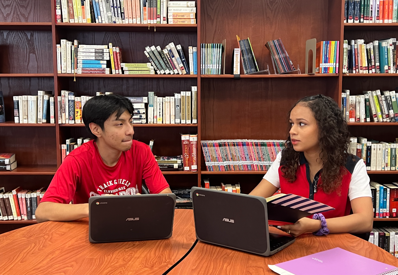 two students working on the laptop