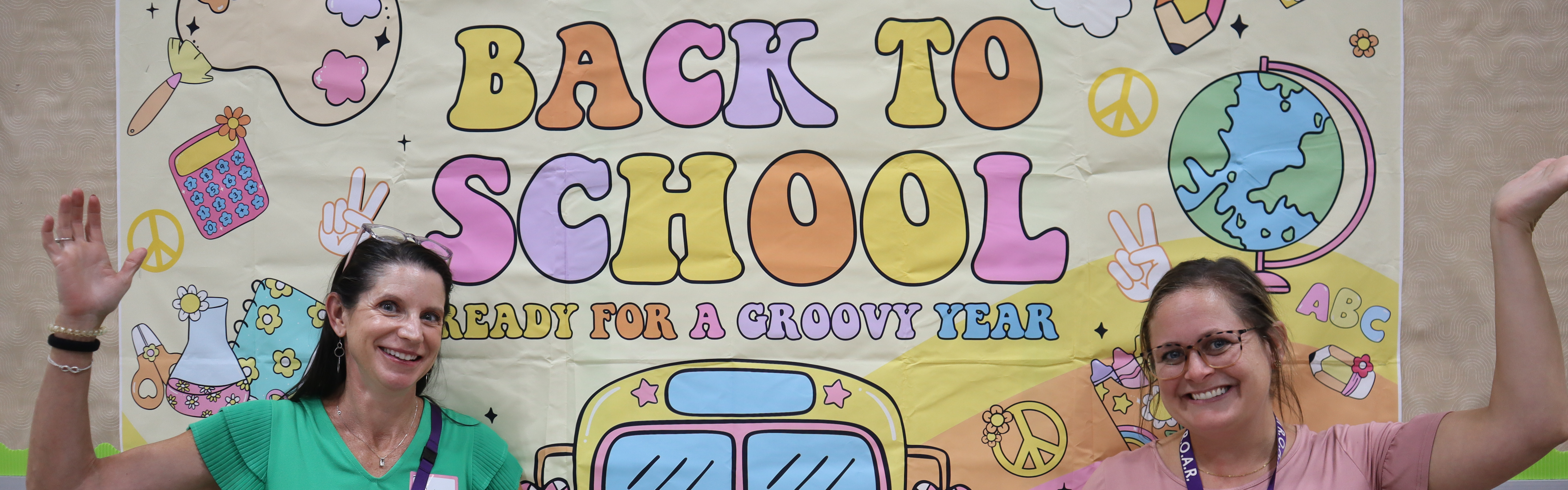 Photo of UMPS Principals standing in front of Back to School banner