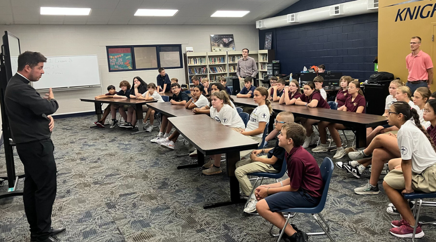 Father Marshall visits with Students