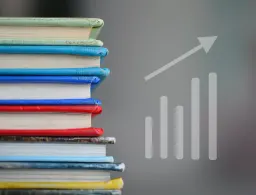 Pile of books and a chart with an arrow going up