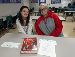 students and adult smiling to camera