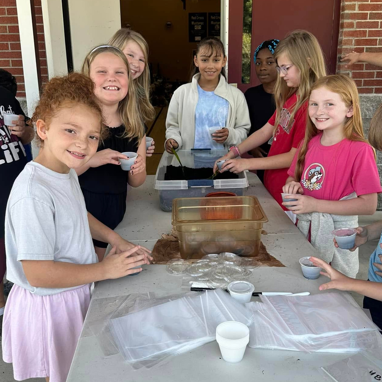 students planting seeds