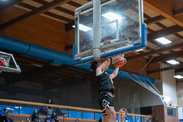 A Napavine High School boys basketball player dunks the basketball during a road game at Toutle Lake