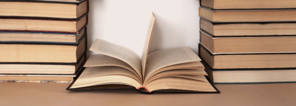 Books laid out in two piles with one open in the middle